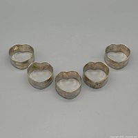 Set of five heart-shaped napkin rings arranged face up