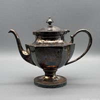 Left profile of silver-plated hexagonal teapot on pedestal base