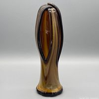 Front view of amber art glass vase showing pulled lobes and colour gradient