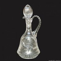 Full view of clear cut crystal decanter with stopper