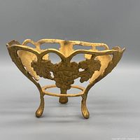 Front angled view showing grapevine panels, legs, and gilt finish