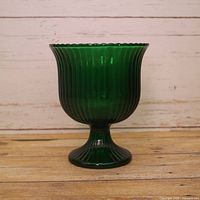 Front view of green pressed glass vase