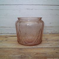 Front side view of pink depression glass cookie jar
