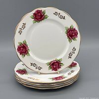Front view of stacked Picardy Rose plates showing floral motif and gold trim