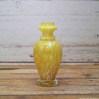 Full view of yellow swirled glass vase front