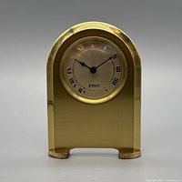 Front view of brass arched desk clock showing dial with 1989 marking