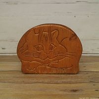 Front view showing carved cat face and overall shape