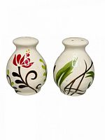 Front view of both ceramic shakers showing floral motifs