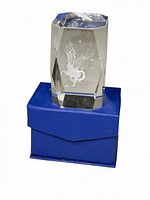 Crystal paperweight standing on blue box showing Pegasus etching