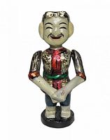 front view of carved wooden puppet figurine showing face, torso and paint details