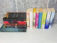 Full group of 13 books lined together showing covers and spines