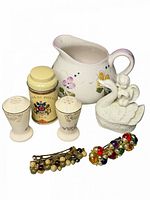 Group shot of entire lot showing pitcher, tea tin, shakers, figurine and two bracelets