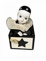 Front view showing porcelain clown in box with star applique