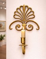 Full view of brass wall sconce on wall, candle inserted