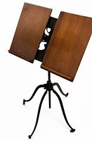 Front view showing double wooden panels and cast-iron base