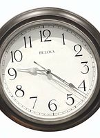 Front view of Bulova clock showing frame, dial and numerals