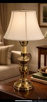 Full view of brass table lamp on table