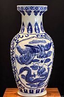 Front view of blue and white porcelain vase showing phoenix and dragon decoration