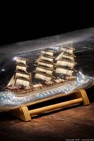 Overall view of ship in bottle on stand