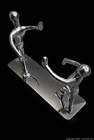 Close view of both stainless steel human-figure bookends on base