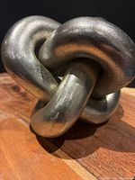 Front angle of textured gunmetal knot sculpture