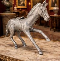 Three-quarter view of silver-tone horse sculpture on marble surface