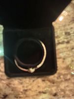 Bracelet inside open black box on countertop