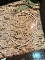 Necklace laid flat showing entire chain and clasp