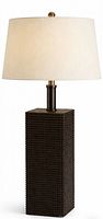 Full view of lamp showing woven base, metal neck, finial, and staging shade