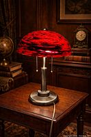 Lamp illuminated on wooden table showing full profile