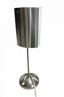 full view of lamp unlit showing brushed steel shade, stem, and base