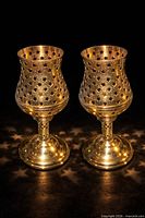 Both brass candle holders side by side