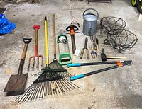 All garden tools and planters laid out on floor