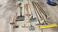 All twelve garden tools laid out on floor