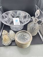 Group shot showing crystal bowl, vinegar cruet, two shakers, stack of four coasters