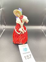 Front view of Royal Doulton Christmas Morn figurine showing red attire and bonnet