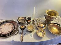 Group shot of entire lot displaying trays, bowls, ladle, goblets, pitcher, candle holder and wine cooler