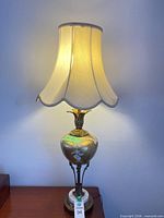 Full view of vintage brass and ceramic table lamp with shade