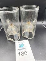 pair of Wolfard glass oil lamps front view