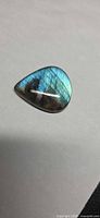 Front view of pear-shaped labradorite showing blue flash