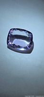 Top view of cushion-cut amethyst showing colour and facet pattern