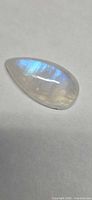 Top view of pear cabochon showing blue flash