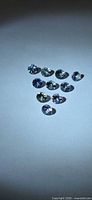 Ten round faceted Tanzanite stones arranged in triangle formation