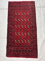 Full view of the rectangular red Torkaman rug