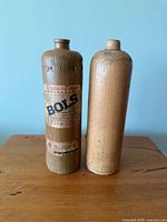 Front view of both stoneware bottles showing label on one