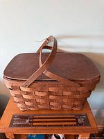 Front angled view showing basket, lid, handles and ruler for scale