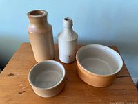 Group shot of two bottles and two crocks