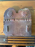 Front view of entire ceramic slab showing sun motifs and bead band