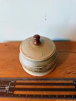 Front view showing jar with lid and scale