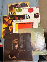 All six record jackets fanned out on surface